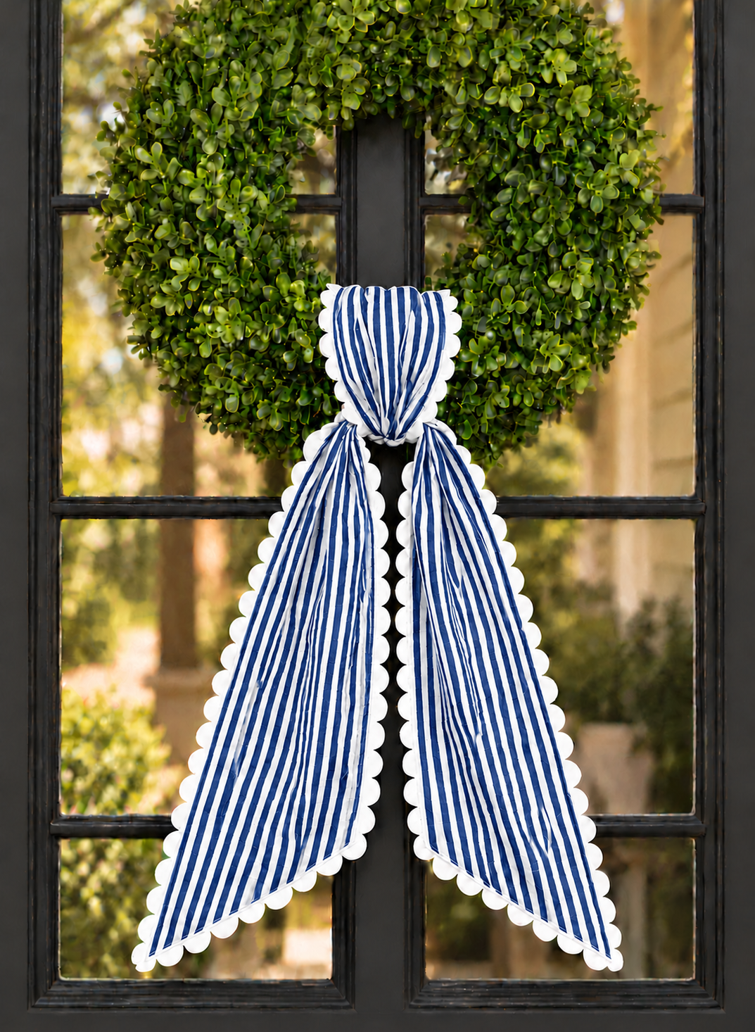 Navy stripe wreath sash with white scalloped ric rac trim, embroidery blank on a boxwood wreath