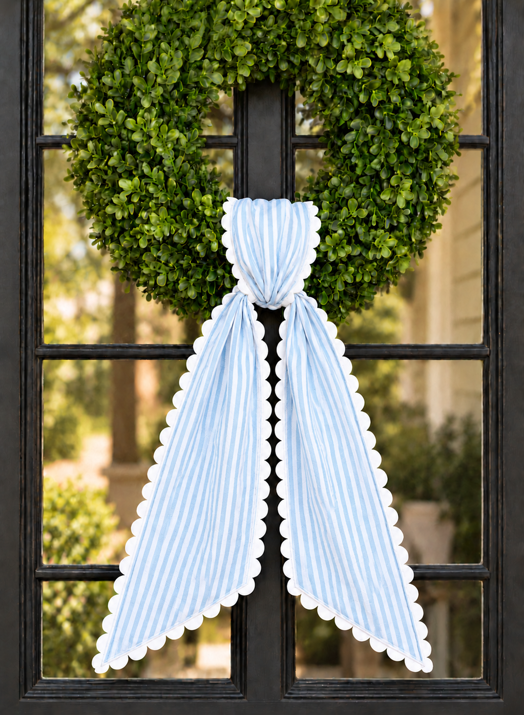 Light blue stripe wreath sash with white scalloped ric rac trim, embroidery blank on a boxwood wreath