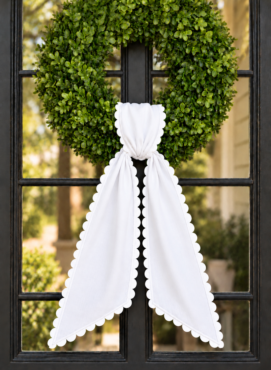 White wreath sash with white scalloped ric rac trim, embroidery blank on a boxwood wreath