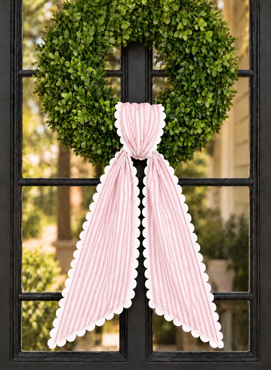 Pink stripe wreath sash with white scalloped ric rac trim, embroidery blank on a boxwood wreath
