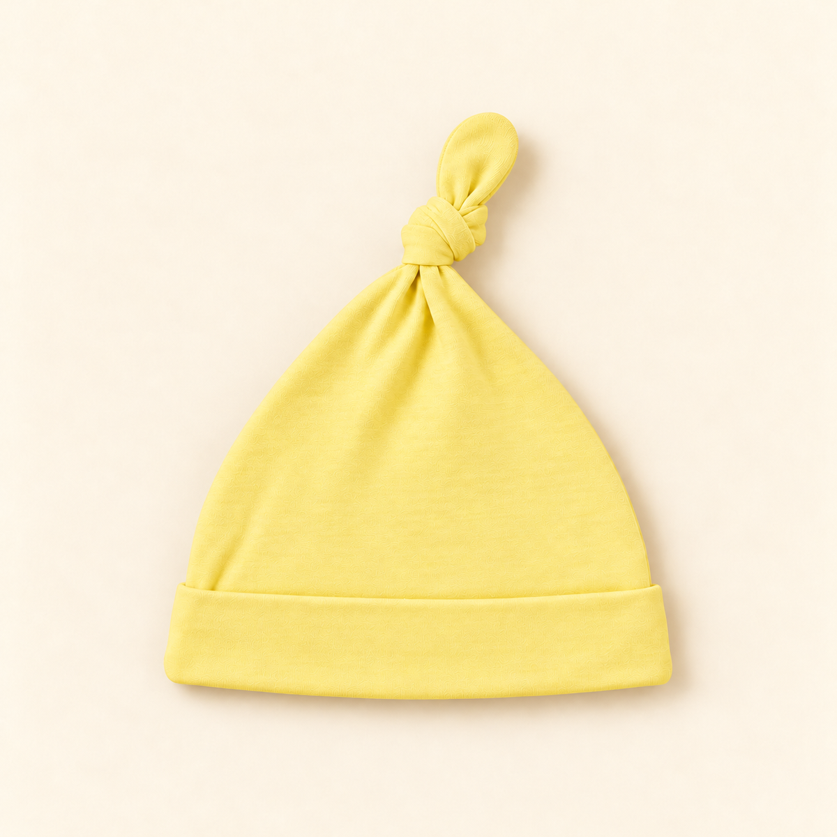 Yellow Baby Knot Hat on cream background