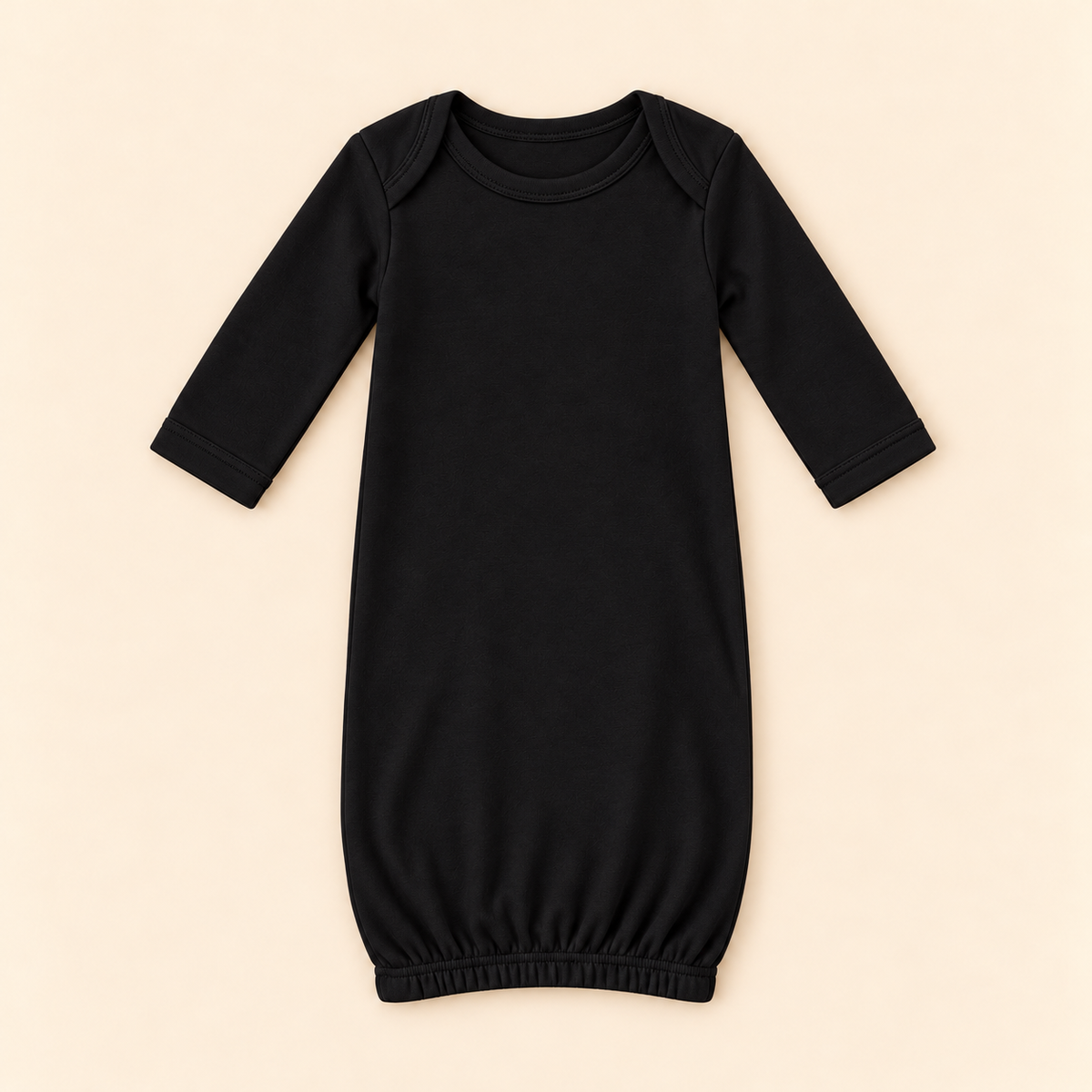 A black long-sleeve baby sleep sack with an elastic hem, laid flat on a light beige background.