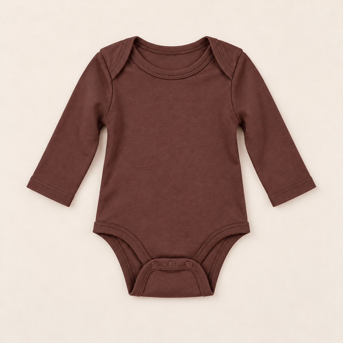 A long-sleeve baby bodysuit in a solid dark brown color, laid flat on a light beige background.