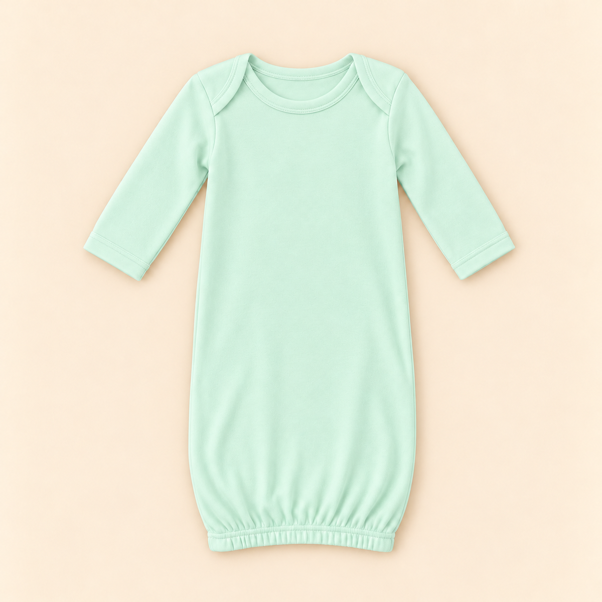 A mint green long-sleeve baby sleep sack with an elastic hem, shown flat on a light peach background.