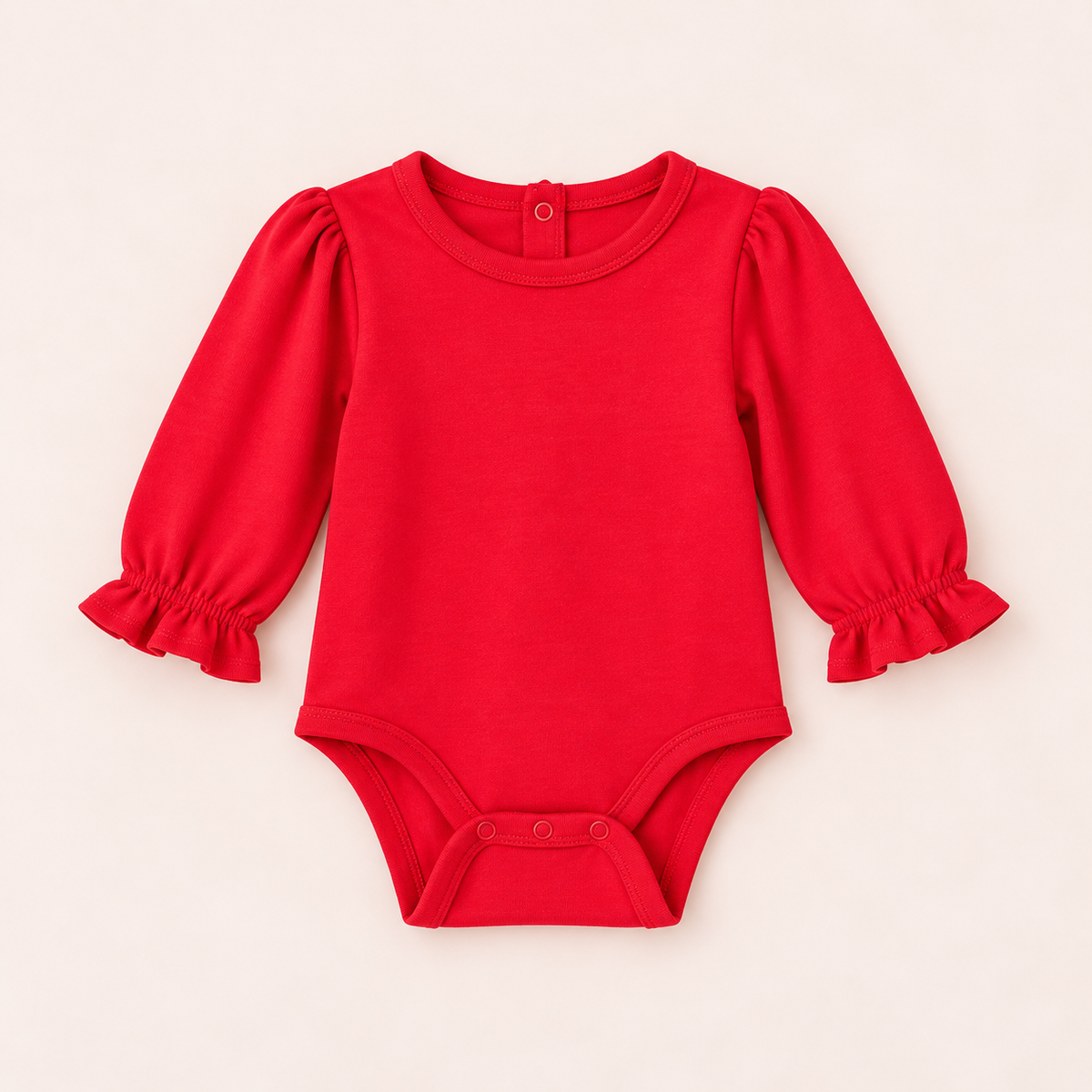 A bright red baby bodysuit with long puff sleeves and ruffled cuffs, laid flat on a light beige background.