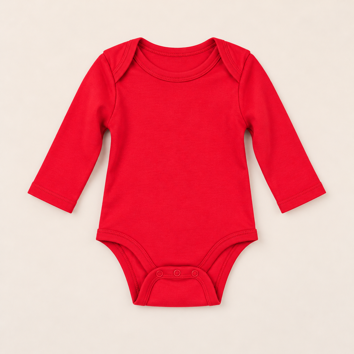 A bright red long-sleeve baby bodysuit with three snap buttons at the crotch, laid flat on a light beige background.