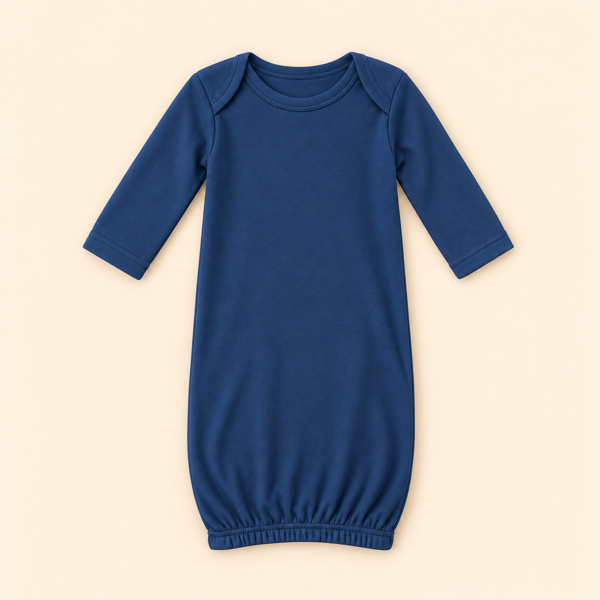 A solid navy blue baby sleep sack with three-quarter sleeves and an elastic hem, laid flat on a warm beige background.