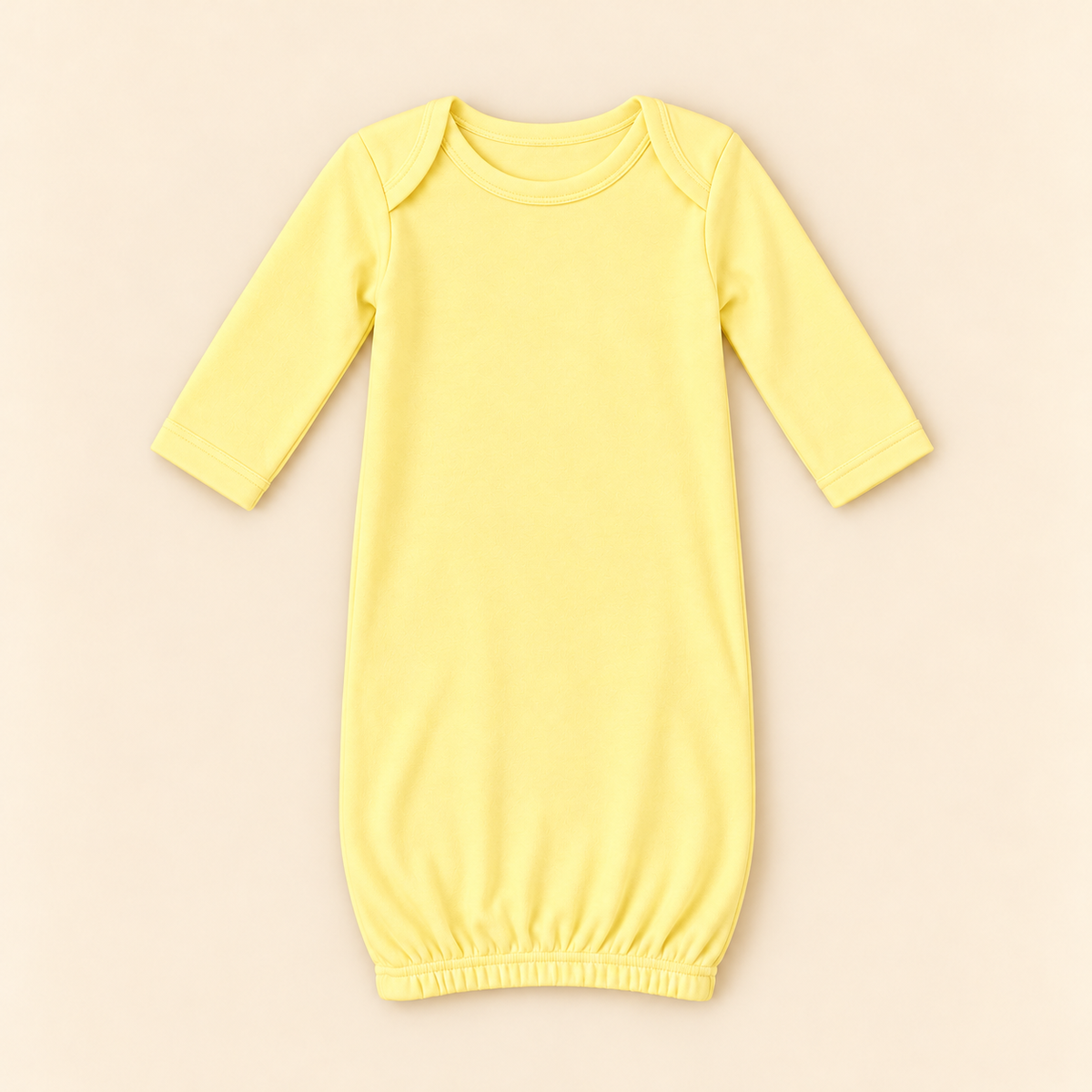 A pale yellow long-sleeve baby sleep sack with a crew neck and elastic hem, laid flat on a light beige background.